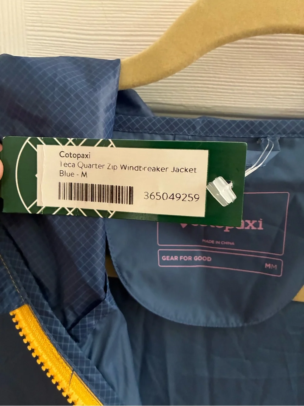 cotopaxi Navy Jacket with Yellow Zipper and Pink Logo